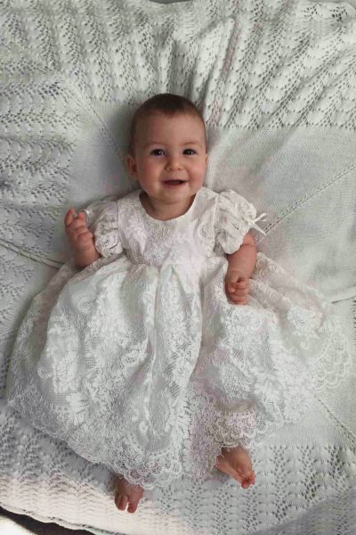 baby in a lace christening gown
