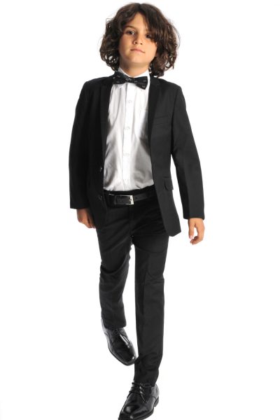 young boy in a black suit, white shirt and bow tie
