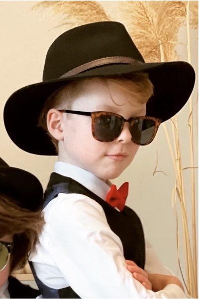 young boy in a black wool felt fedora hat, shirt and bow tie